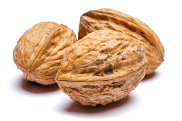 three whole walnuts isolated on white background. clipping path