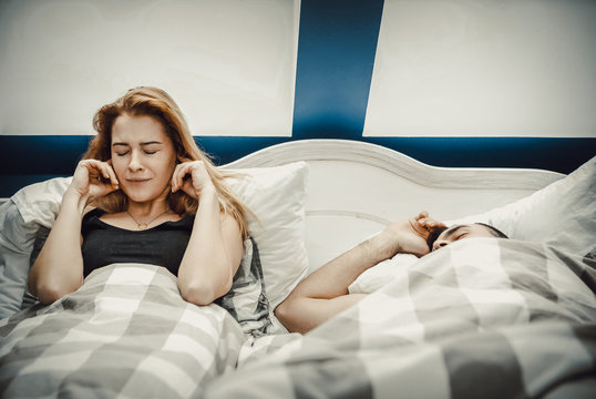 Snoring man in bed with wife