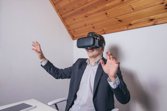 Young businessman enjoying virtual reality headset