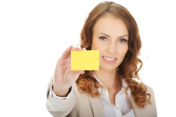 Businesswoman holding blank card.