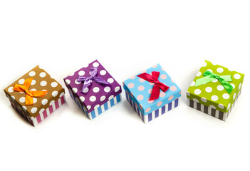 Group of gifts from multi-colored boxes with ribbons on white background