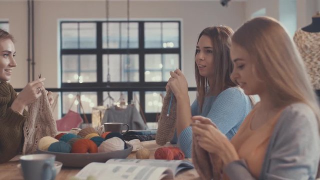 Smiling girls in a knitting lesson