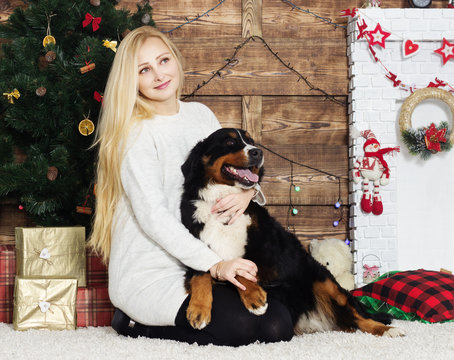 woman and a dog near a Christmas tree