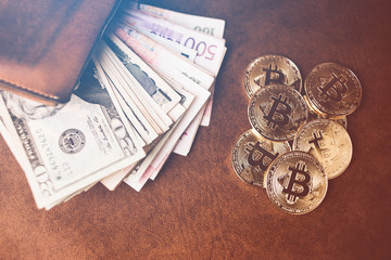 golden bitcoin coin on internation mpny bill with wallet on brown leather background business ideads concept