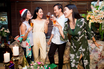 Many friends drinking wine in the party at night.