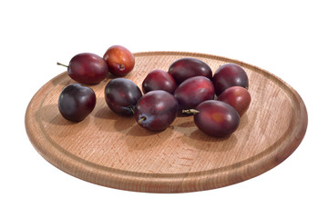 Ripe fresh plum on a tray. On isolate