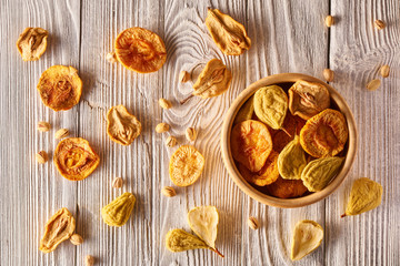 Dried fruits and nuts on wooden background