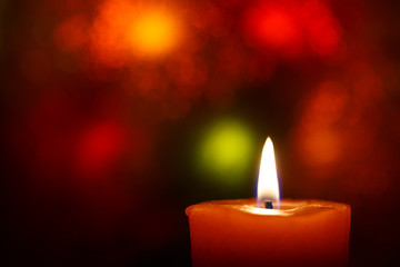 Burning candle on a blurred background