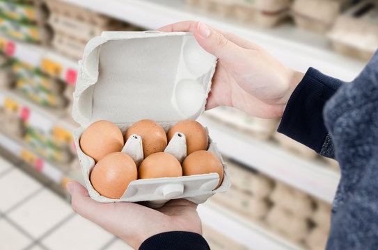 Man buys eggs in the supermarket
