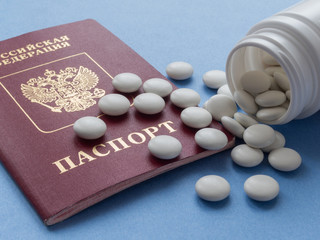 Russian passport and white round tablets. Sports doping, anabolic drugs, pills and tablets. Vitamins