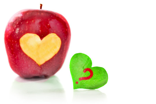 Red apple and the heart which is cut out from apple