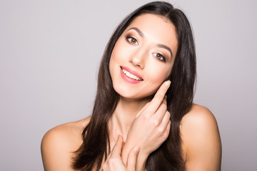 Beautiful elegant young woman with natural nude make up on white background. Professional makeup, perfect skin.