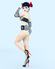 3D sexy girl doll big blue eyes and bright makeup. Woman retro style black shorts. High heel. Bow dark hair. Conceptual fashion art. Seductive candid pose. Realistic render illustration.