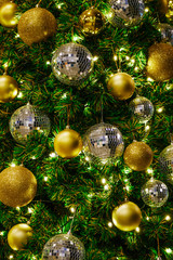 Obraz na płótnie Canvas Sparkle golden Christmas ornament and golden light on pine tree Christmas,holiday,festive concept