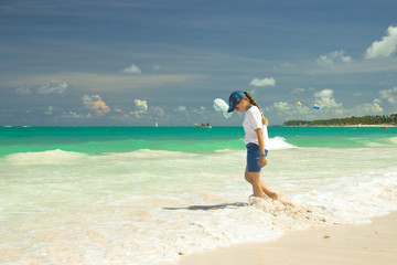 Fototapeta na wymiar A girl on the beach in Punta Cana, Dominican Republic.