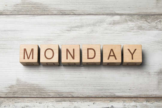 MONDAY word written on wooden cubes on wooden background