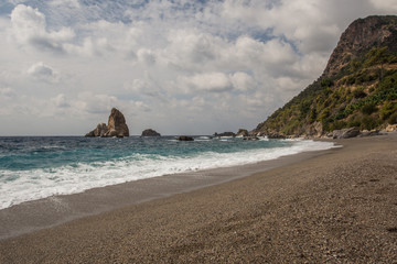 Picturesque beach with rocks in sea