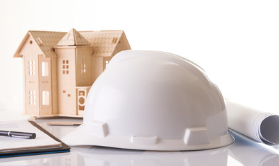 Helmet or hard hat, rolled construction blueprints