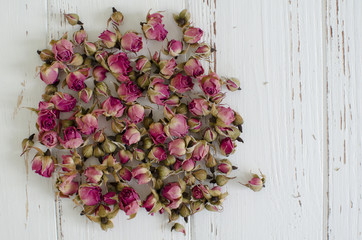  Dry roses on the wooden background