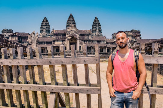 Man in the ruins of Angkor Wat. Backpacker traveling in Siem Reap, Cambodia.