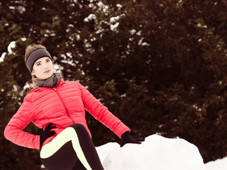 Woman wearing sportswear exercising during winter