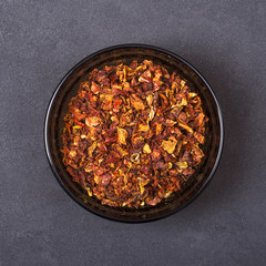 Tomato spice in a bowl on a grey concrete background