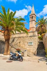 Naklejka premium Scooter parking in front of a church in Splitska village, Brac island, Croatia