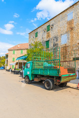 SPLITSKA PORT, BRAC ISLAND - SEP 7, 2017: delivery truck parking in picturesque Splitska village on Brac island, Dalmatia, Croatia.