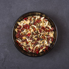 Spice mix - paprika and dried onion in a bowl on a grey concrete background
