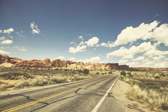 Retro toned picture of a scenic road, travel concept, USA.