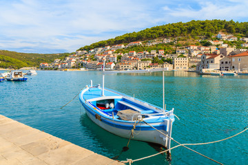 Fototapeta na wymiar Fishing boat mooring in picturesque Pucisca port, Brac island, Croatia