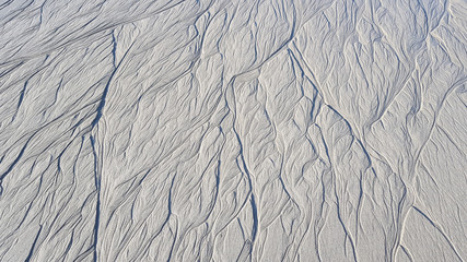Traces on sand from sea water. Textures