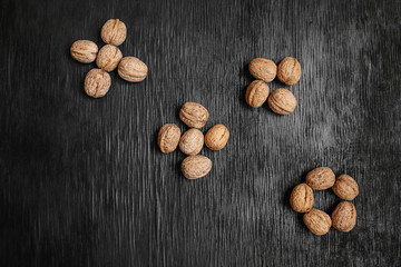 Lots of fresh nuts on a black wooden background. Best practices for designer. A beautiful design from the nuts