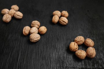 Lots of fresh nuts on a black wooden background. Best practices for designer. A beautiful design from the nuts