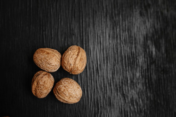 Lots of fresh nuts on a black wooden background. Best practices for designer. A beautiful design from the nuts