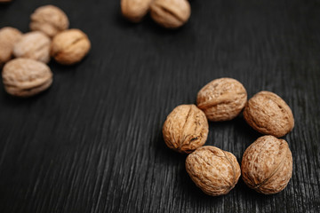 Lots of fresh nuts on a black wooden background. Best practices for designer. A beautiful design from the nuts