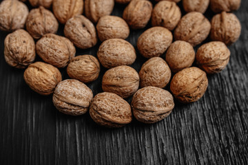 Lots of fresh nuts on a black wooden background. Best practices for designer. A beautiful design from the nuts
