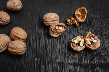 Lots of fresh nuts on a black wooden background. Best practices for designer