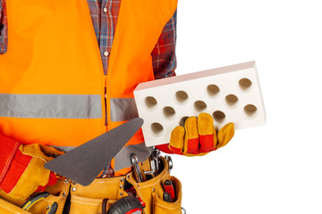 Builder worker with a brick and trowel in hands isolated on white background.