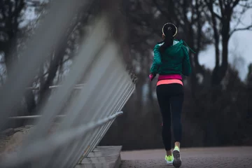 Washable wallpaper murals Jogging Rear view woman jogging outside in cold winter day