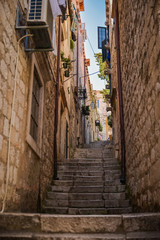 Fototapeta na wymiar Narrow street with steps of medieval city Dubrovnik. Travel postcard vacation concept.