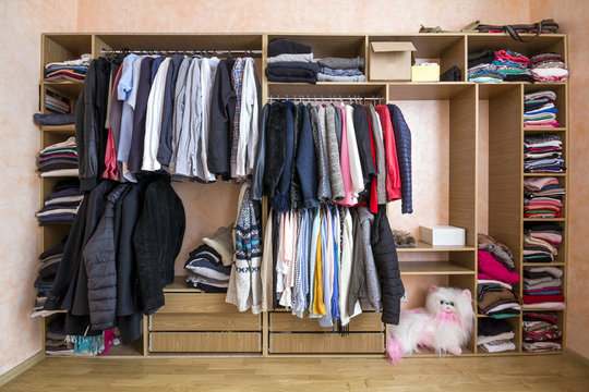 Wardrobe full of different men and woman clothes