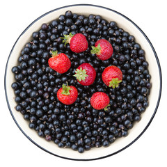 Strawberries and currant black. Bowl with black currant berry and strawberry isolated on white.