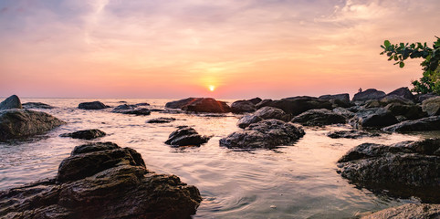 Tropical colourful sunset on the beach of Koh Chang island, Gulf of Siam, Thailand. Panorama view...