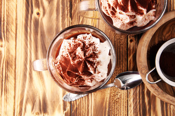 Hot chocolate or coffee with whipped cream in glass.