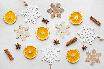 christmas frame composition with dry oranges, cinnamon sticks, anise stars and wooden snowflakes