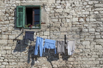 Drying laundry in front of old facade in Sibenik in Croatia