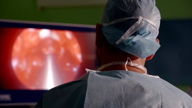 Professional surgeon conducting difficult endoscopy procedure.