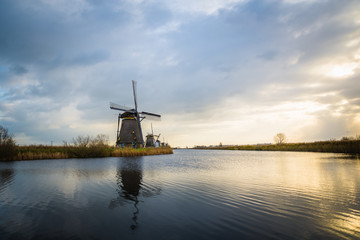 Old windmills in Kinderdijk at sunrise, Holland, Netherlands, Europe. Unesco world heritage site.