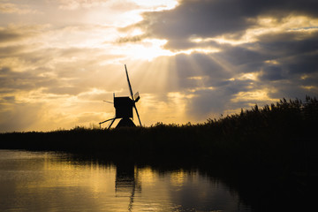 Old windmills in Kinderdijk at sunrise, Holland, Netherlands, Europe. Unesco world heritage site.